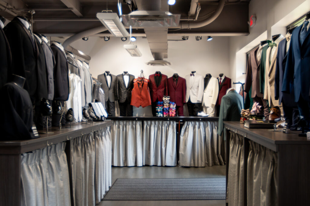 Image of the interior of Modern Tux and their vast selection of tuxes and suits on mannequins.